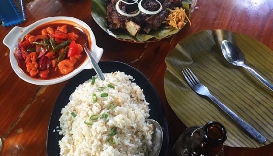 Filipino meal with rice, ulam, spoon, and fork.